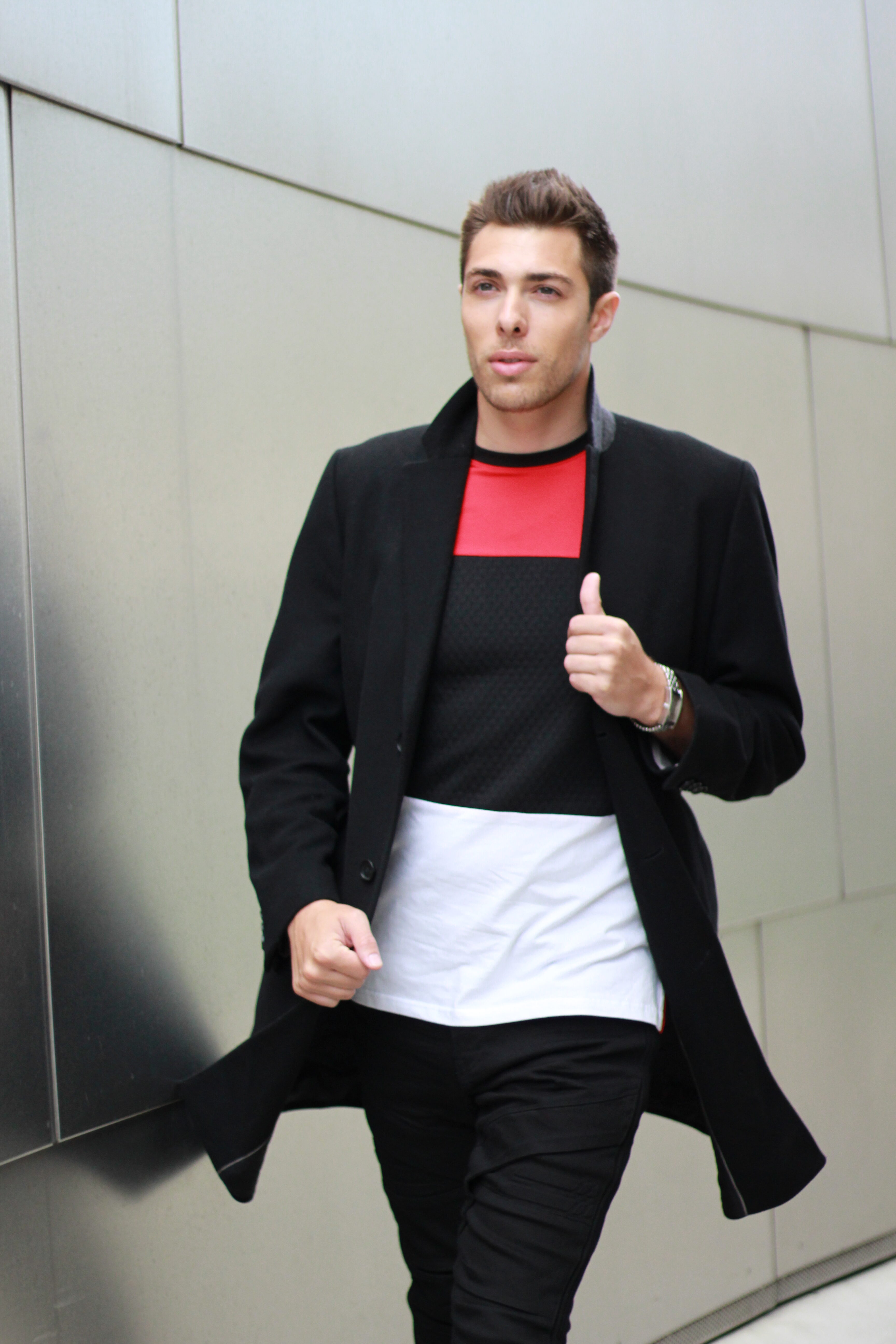 Alex Veach (Alexander Veach) color-block coat fashion portrait, walking pose.