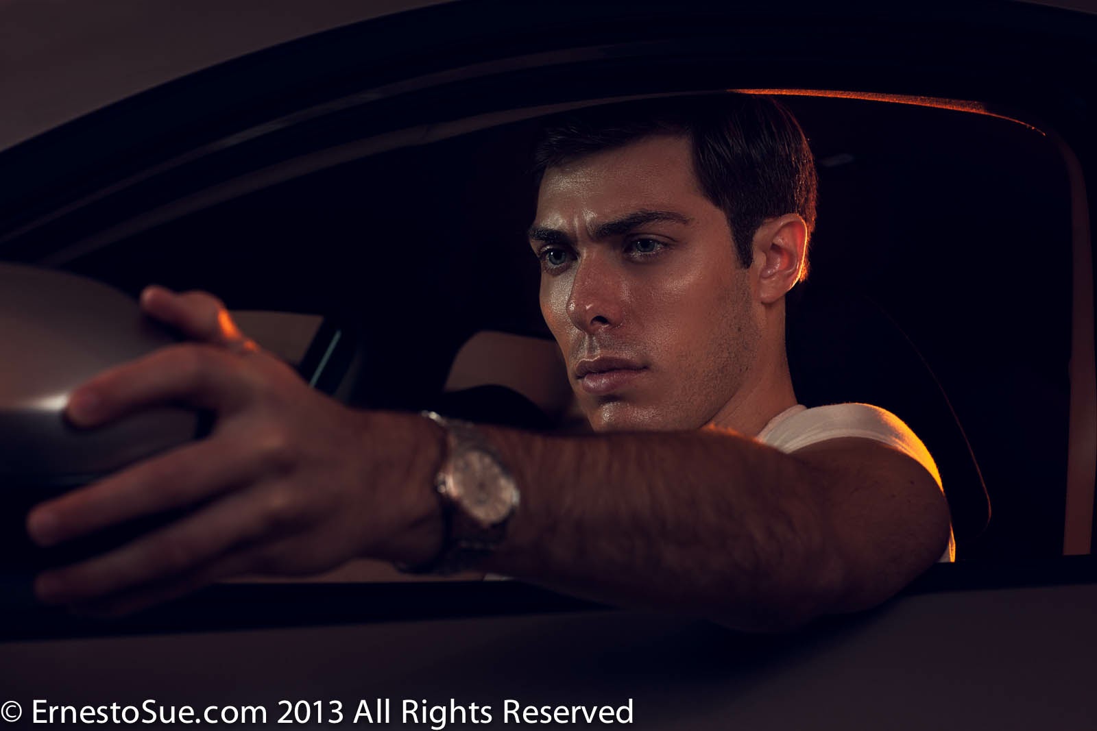 Alex Veach (Alexander Veach) Drive editorial, hands on steering wheel, silver watch, white tee, cinematic car interior.