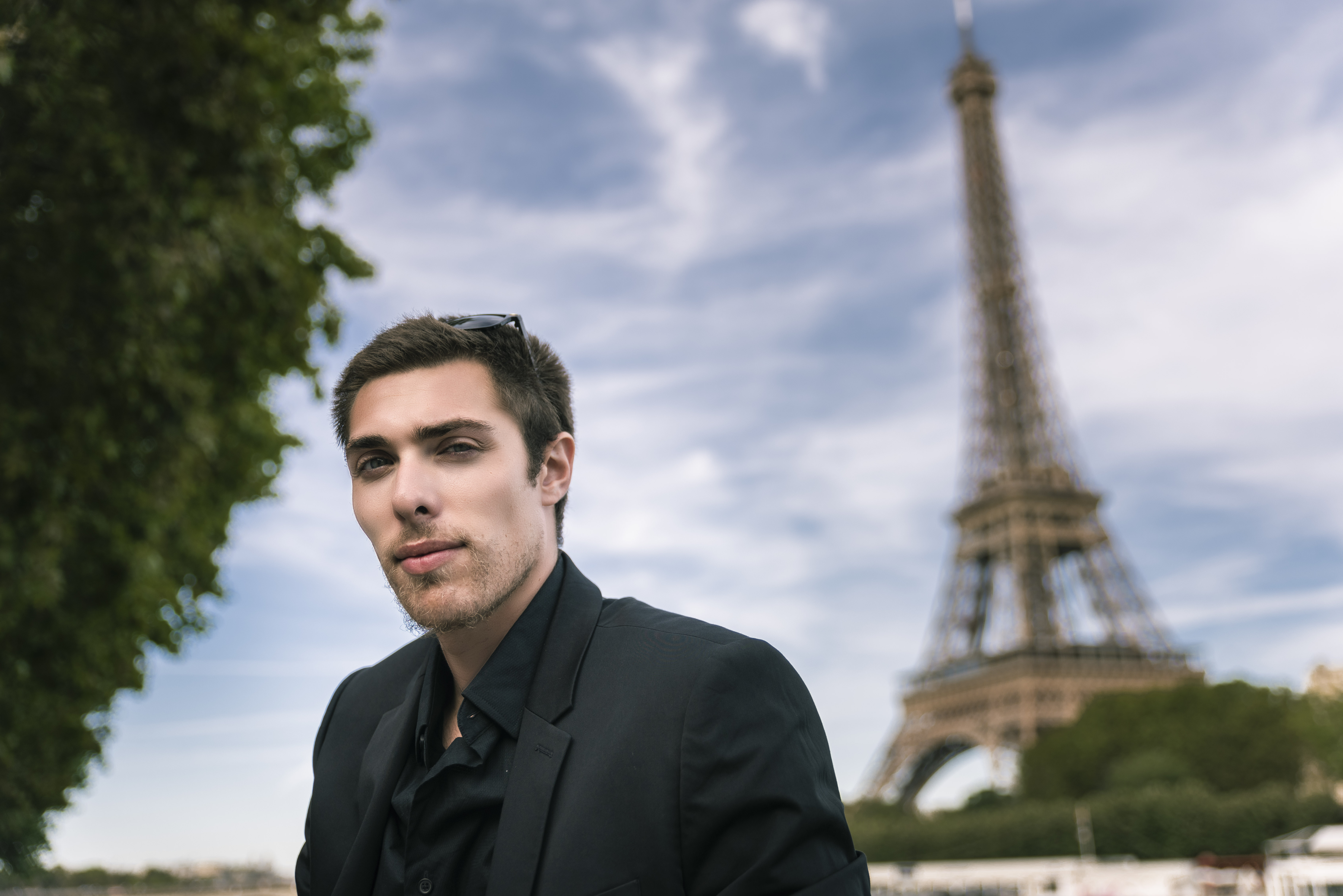 Alex Veach (Alexander Veach) Paris editorial at the Eiffel Tower, blazer, blue sky.