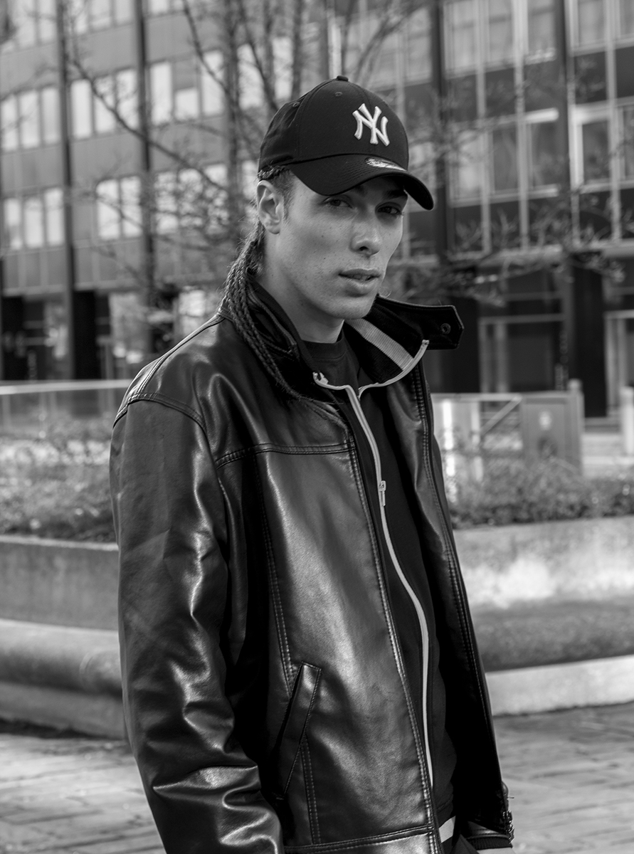 Alex Veach (Alexander Veach) B&W La Defense portrait, Yankees cap and leather jacket.