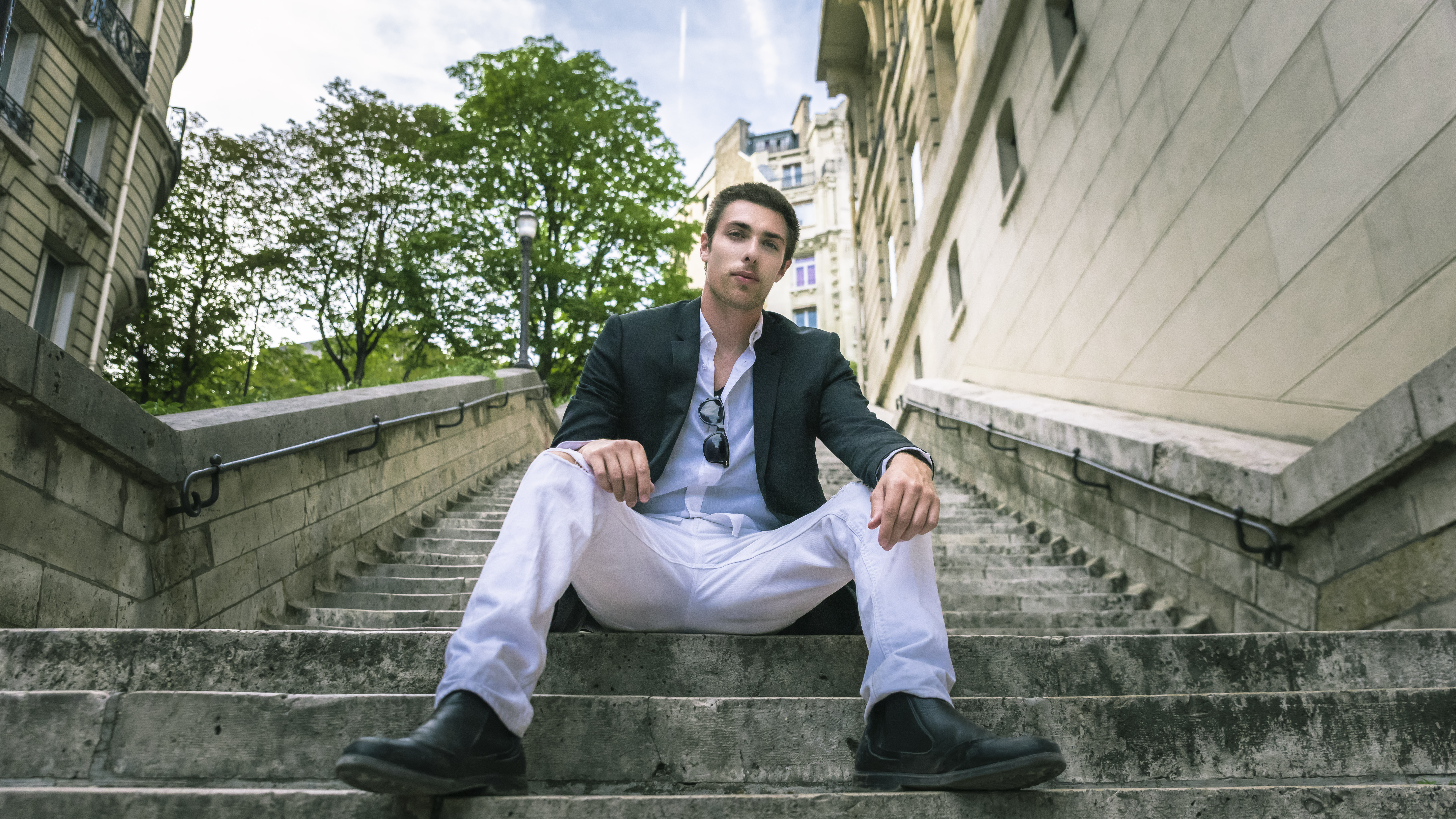 Alex Veach (Alexander Veach) Paris editorial seated on stone staircase, tailored blazer.