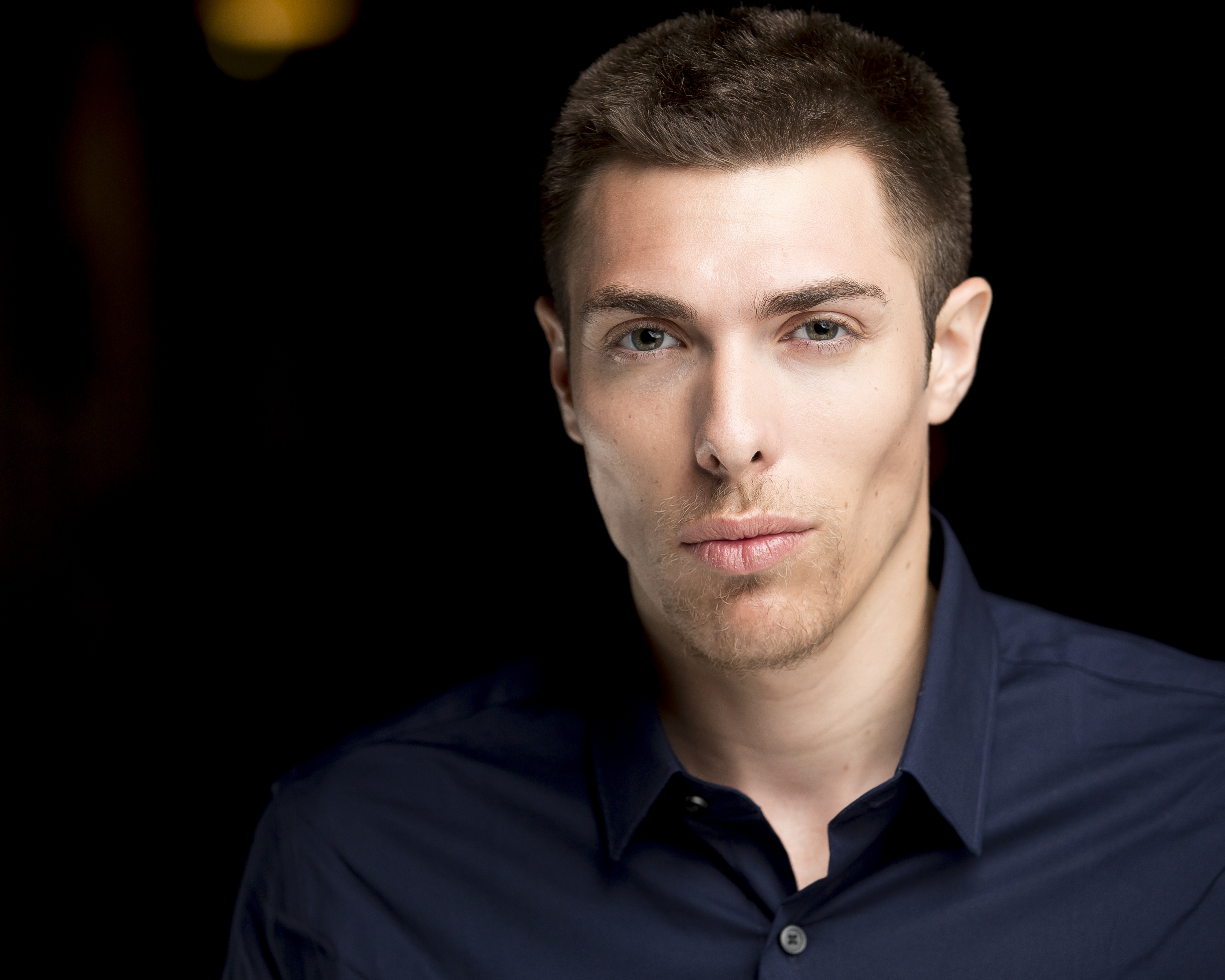 Alex Veach (Alexander Veach) professional studio headshot, navy shirt, natural lighting.