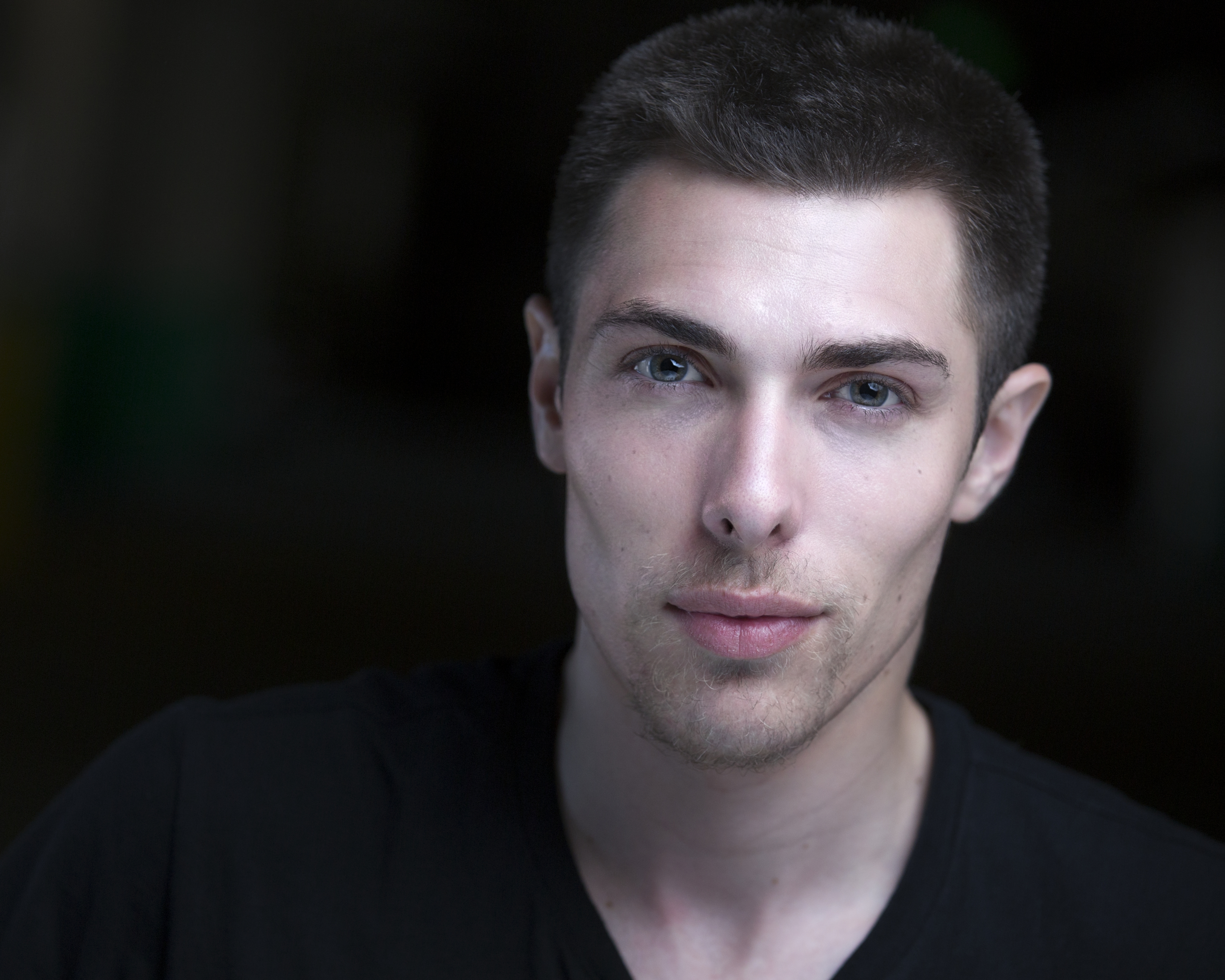 Alex Veach (Alexander Veach) warm-tone professional headshot, subtle smile, studio lighting.