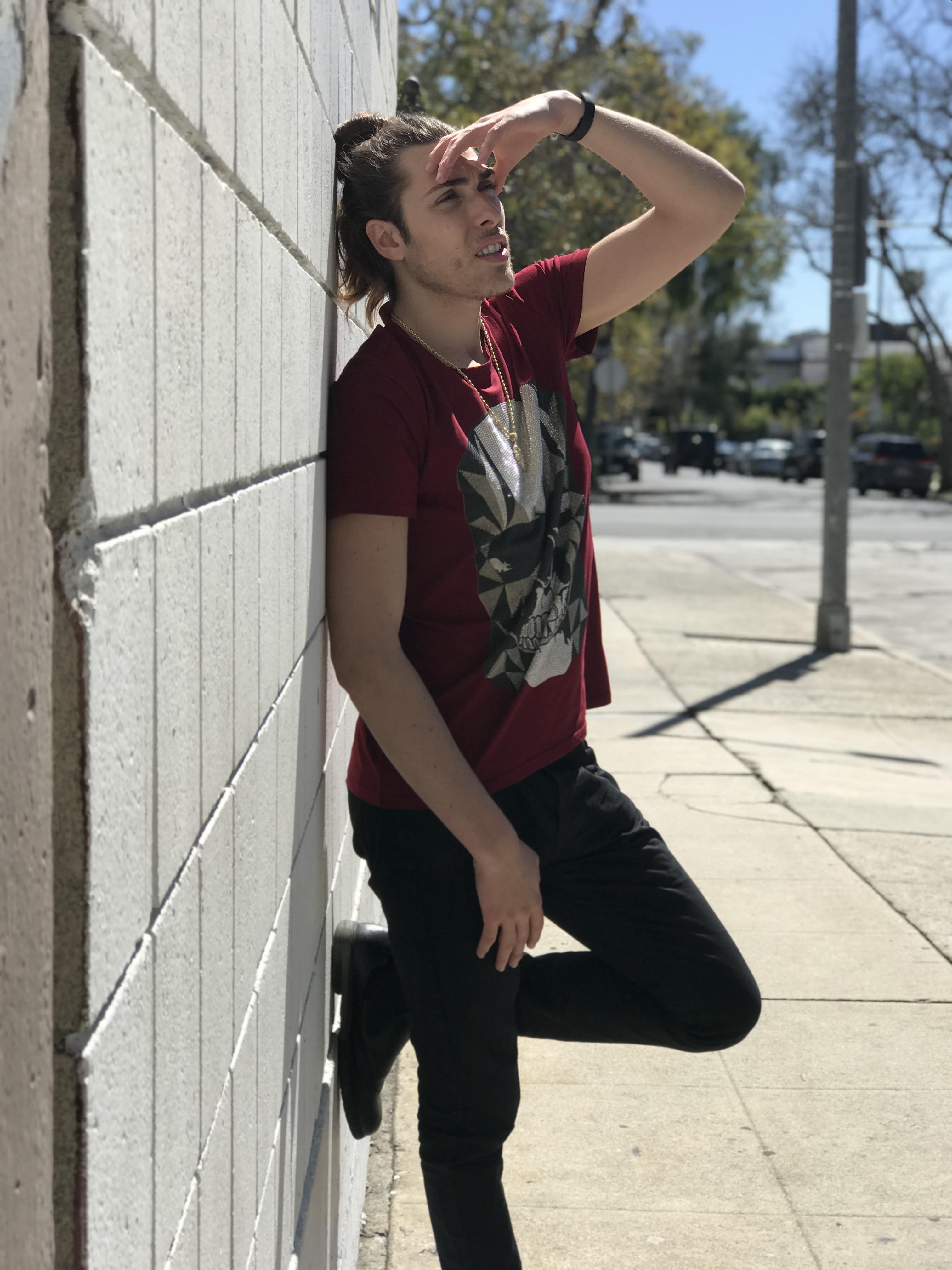 Alex Veach (Alexander Veach) LA streetwear, hand shielding eyes, sunlit street pose.