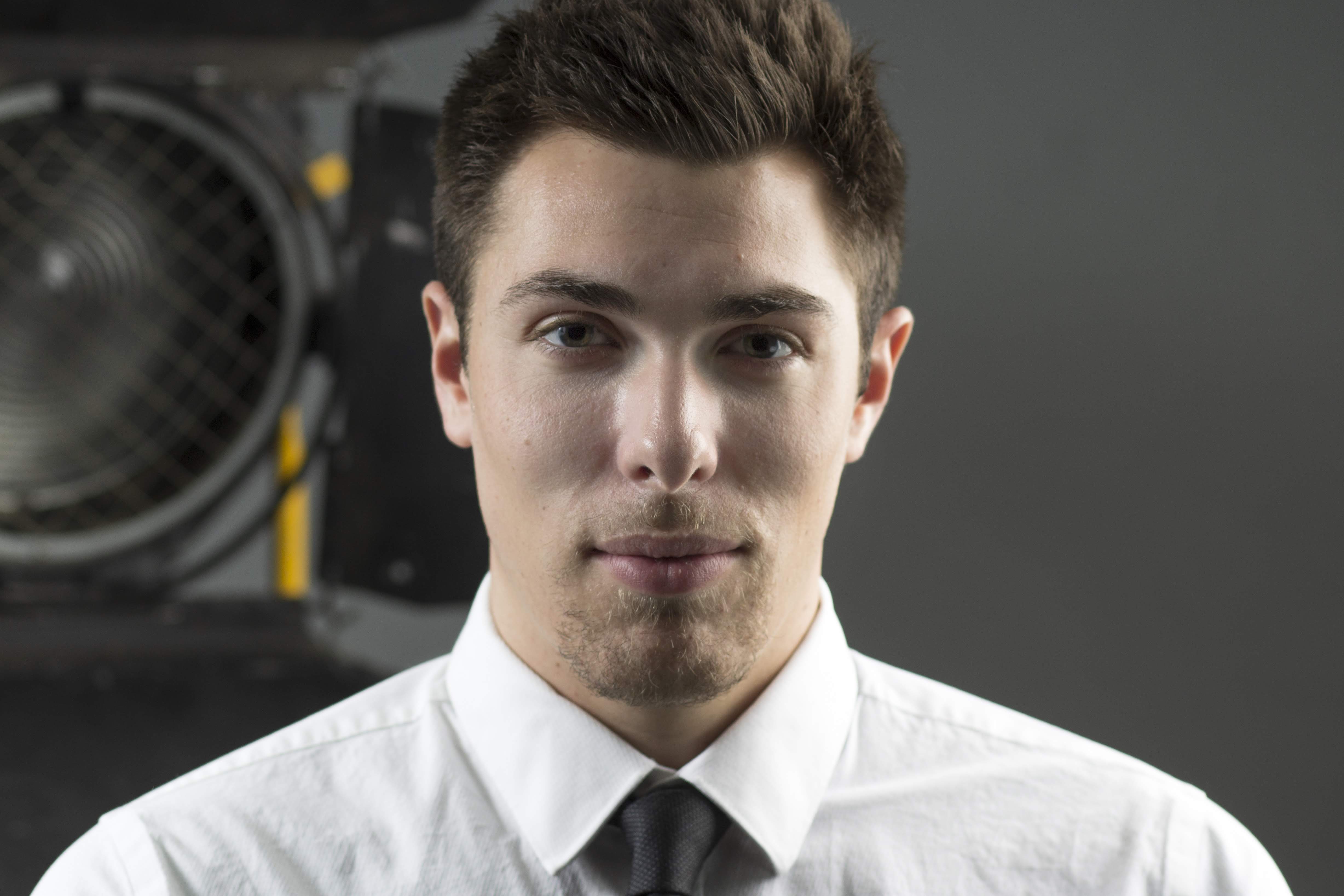 Alex Veach (Alexander Veach) tight studio headshot in white shirt and black tie.
