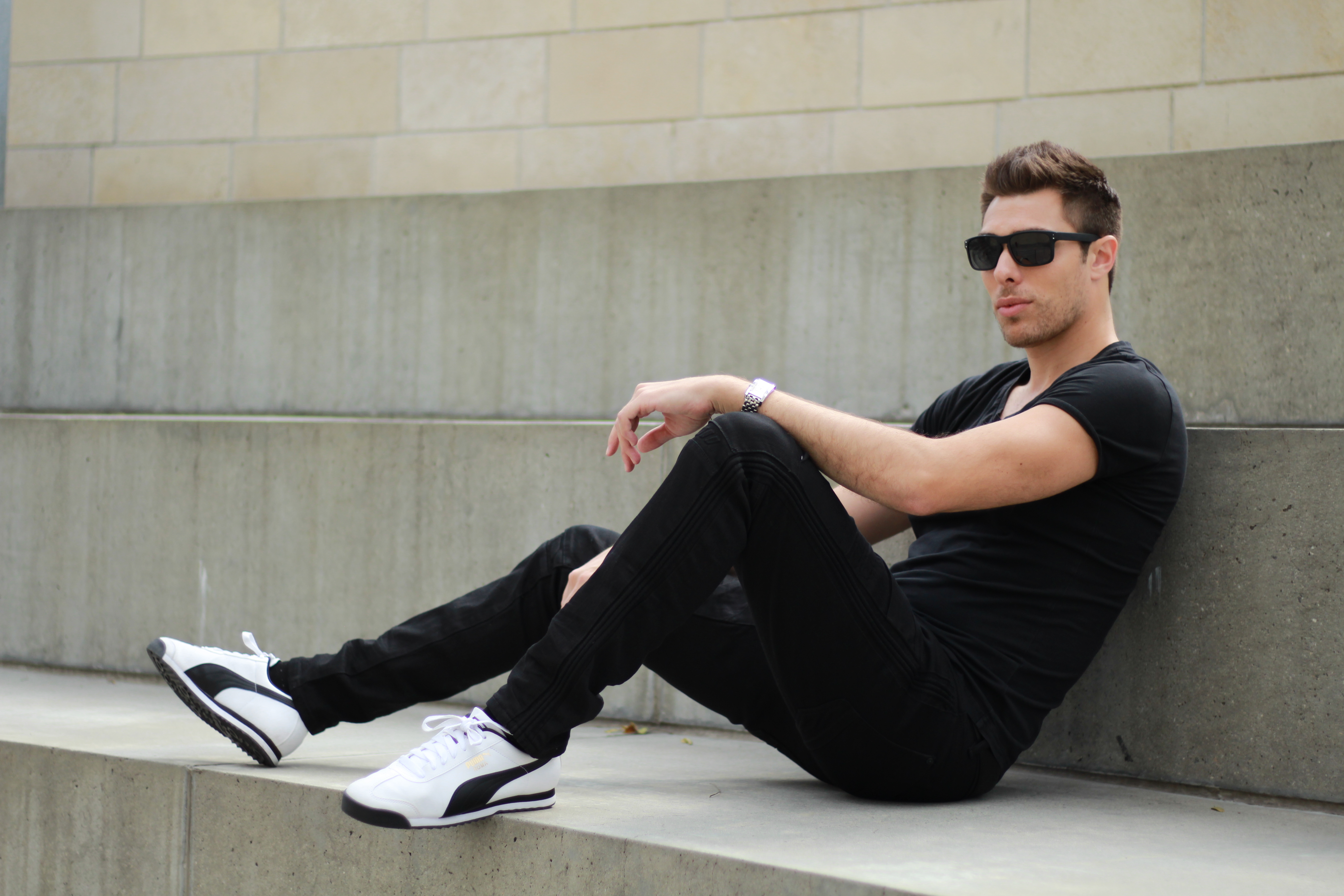 Alex Veach (Alexander Veach) LA street style, all-black seated on concrete urban steps.