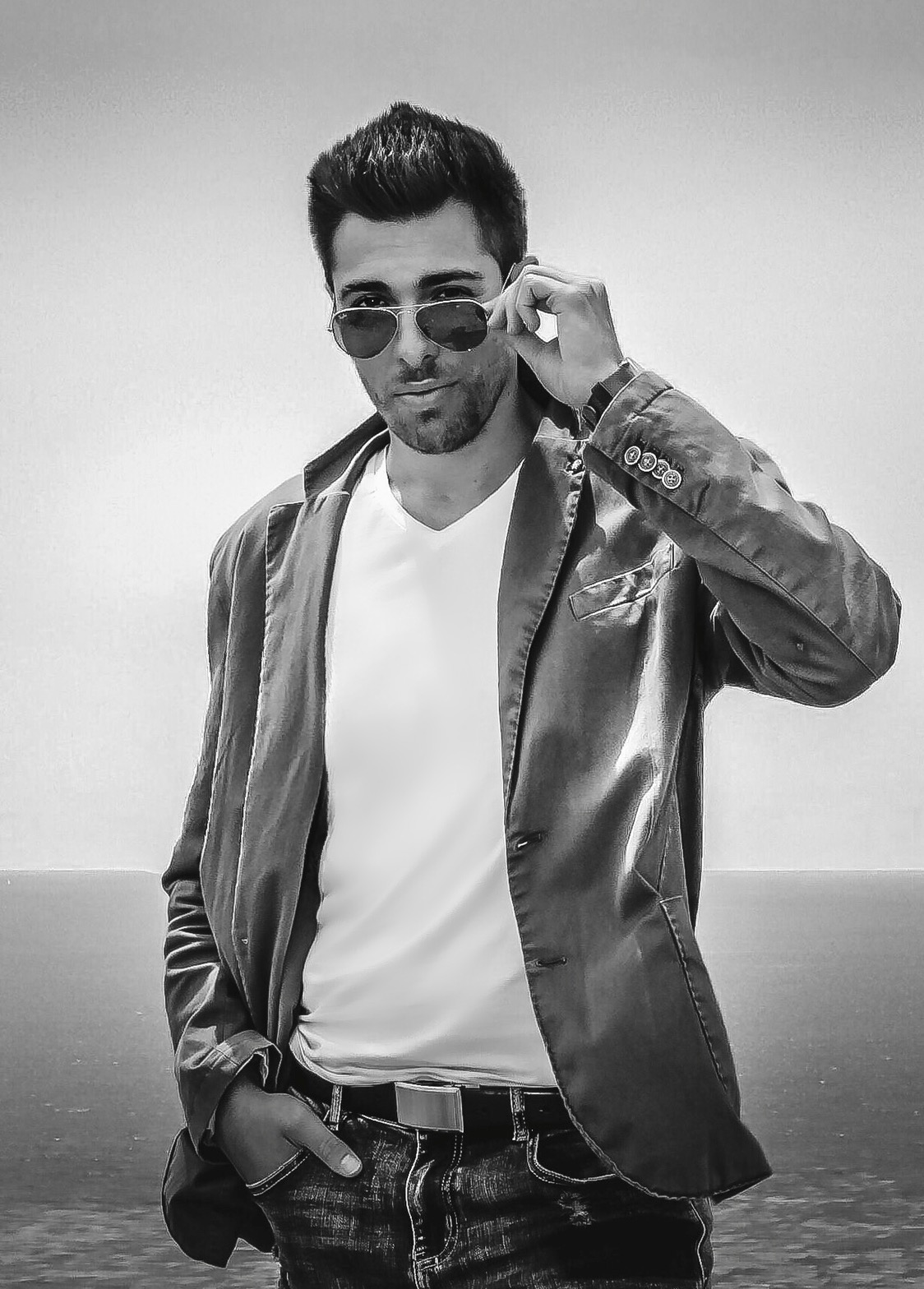 Alex Veach (Alexander Veach) B&W waterfront portrait, blazer and styled aviators.
